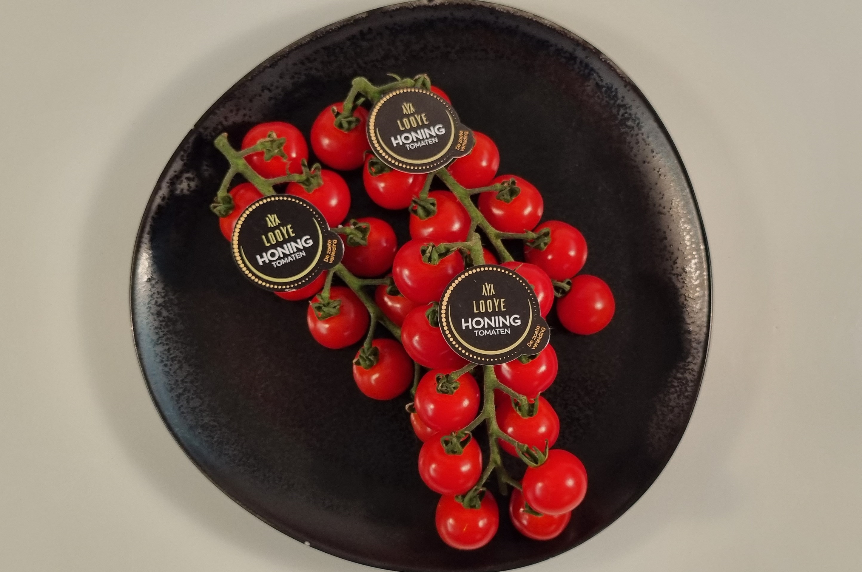 Honing tros tomaatjes van Looijen per doosje a. 3 kilo